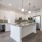 kitchen with green backsplash, island, and wine fridge